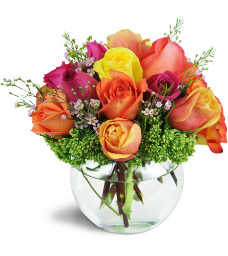 Catch Your Heart™. An arrangement by Avenue Flowers and Gifts. More than a dozen colorful roses are arranged with waxflower and sedum in a...