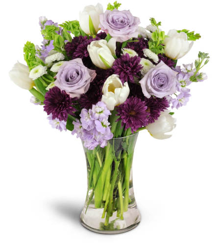 Serene Paradise™ - Deluxe. An arrangement by Avenue Flowers and Gifts. White tulips, Bells of Ireland, and more are beautifully arranged in a...