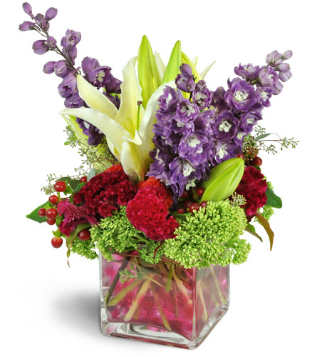 Magnificent Jewel™. An arrangement by Avenue Flowers and Gifts. Lilies, delphinium, bells of Ireland, and more, all in luxe jewel tones, are...