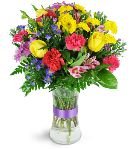 Budding Blooms. An arrangement by Avenue Flowers and Gifts. Yellow roses, red and pink carnations, alstroemeria, and a bevy of springtime flowers...