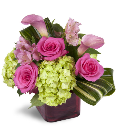 Peek of Chic™ - Deluxe. An arrangement by Avenue Flowers and Gifts. Hot-pink roses, green hydrangea, and pink Peruvian lilies are accented with...