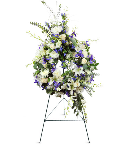 Enduring Love Wreath™. An arrangement by Avenue Flowers and Gifts. Roses, Dendrobium orchids, irises, and more are arranged for display at the...