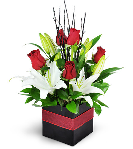 Spectacular Love. An arrangement by Avenue Flowers and Gifts. Rich red roses and lovely white lilies are arranged with black twig accents in a...
