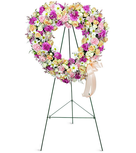 Loving Thoughts Wreath. An arrangement by Avenue Flowers and Gifts. Featuring spray roses, carnations, and daisies in gentle tones of pink....