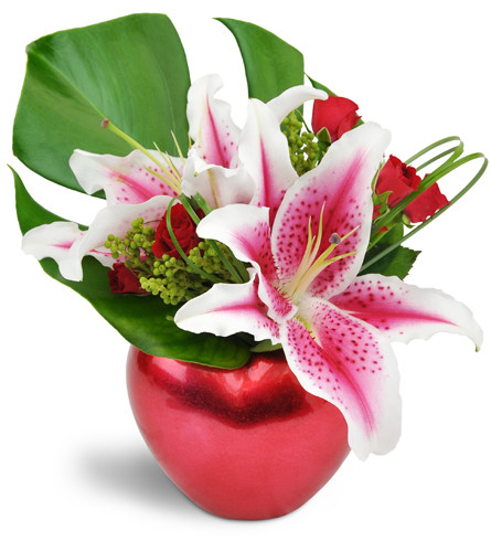 Starry-Eyed Love™. An arrangement by Avenue Flowers and Gifts. Stargazer lilies and fragrant spray roses are arranged in a red heart-shaped...